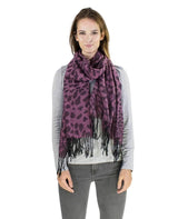 Woman in purple floral scarf on leopard print pashmina with tassels.