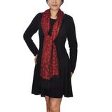 Woman in black dress and red scarf wearing Warm Leopard Print Pashmina Scarf with Tassels