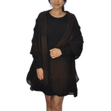 Woman wearing black dress and brown cardigan featuring Warm Oversized Checked Blanket Scarf.