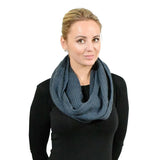 Stylish woman in plain knitted snood and black shirt