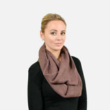 Woman wearing warm brown plain knitted snood for winter.