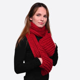 Winter chunky knitted scarf with pockets on woman.