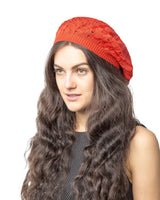 Woman wearing red cable design knitted beanie hat