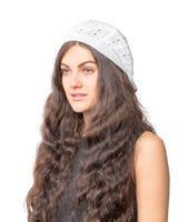 Woman with long brown hair wearing white knit hat from Women’s Cable Design Knitted Crochet Beanie Hat.