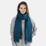 Woman wearing a blue leopard print winter scarf.