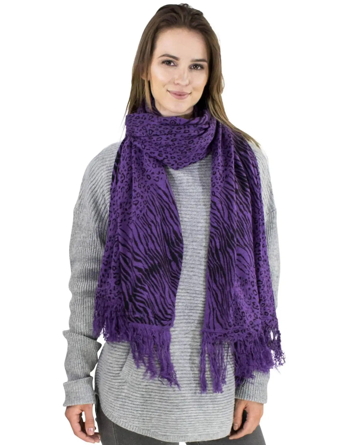 Woman wearing purple leopard and zebra print winter scarf.