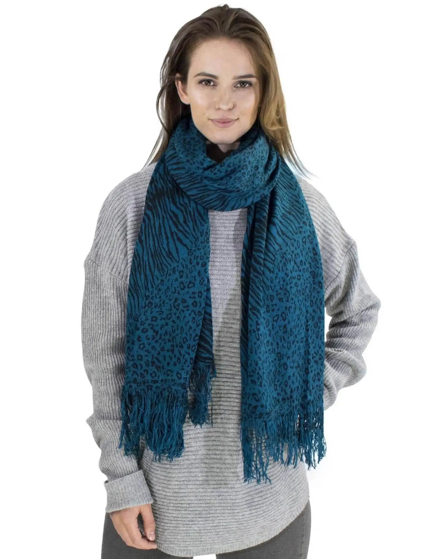 Woman wearing a blue leopard and zebra print winter scarf.