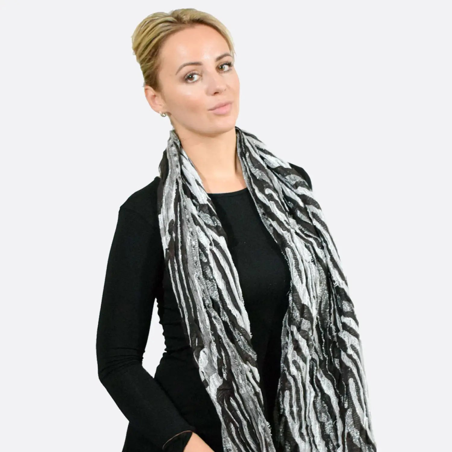 Zebra print metallic tasselled scarf worn by a woman.